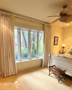 Custom pinch pleat drapery on a decorative white wood track with accent banding adds timeless elegance and a beautifully tailored finish to this Coral Gables, FL home.